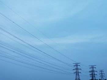 Low angle view of electricity pylon against sky