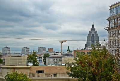 View of cityscape against cloudy sky