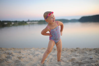Portrait of little girl standing at beach