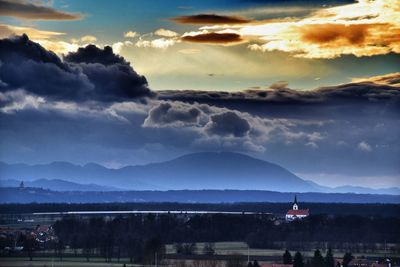 Scenic view of mountains against cloudy sky