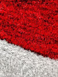 High angle view of snow on red rug