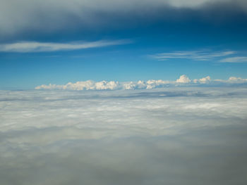 Aerial view of sea against cloudy sky