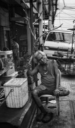 People sitting on street in city