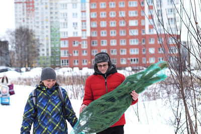 Portrait of smiling couple standing against trees