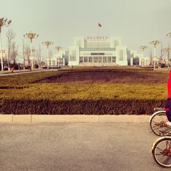 Bicycle in city against sky