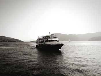 Ship sailing on sea against clear sky