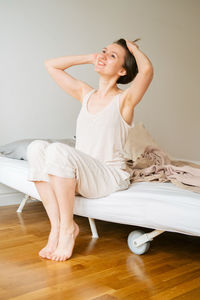 Full length of a smiling young woman at home