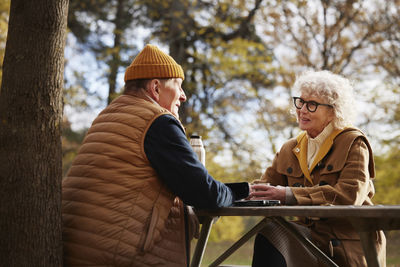 Senior couple at picnic table in park