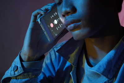 Close-up of woman holding mobile phone