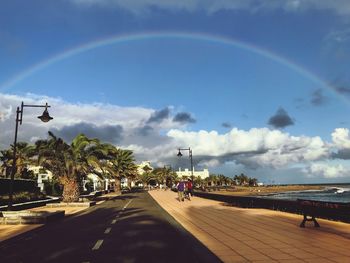 View of rainbow over road in city