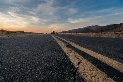 Surface level of empty road against sky