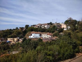 High angle view of trees and buildings against sky