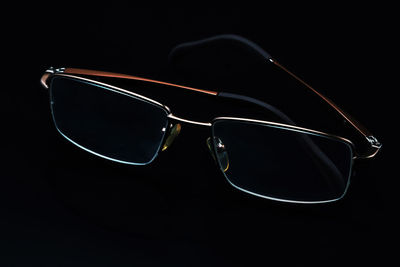 Close-up of sunglasses against black background