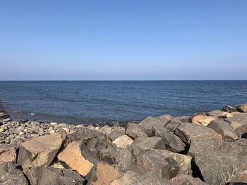 Scenic view of sea against clear blue sky