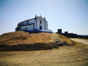 Old building on field against clear sky