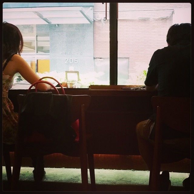 sitting, indoors, men, window, lifestyles, rear view, chair, person, leisure activity, side view, silhouette, relaxation, transportation, glass - material, built structure, travel, mode of transport