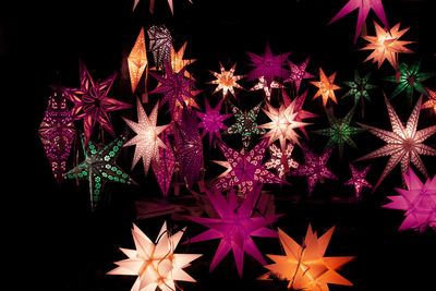 Illuminated star shape christmas decorations at night