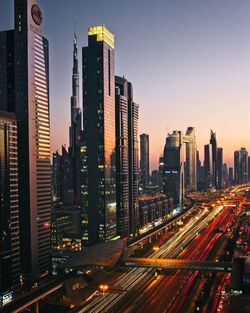 High angle view of illuminated buildings against sky at sunset