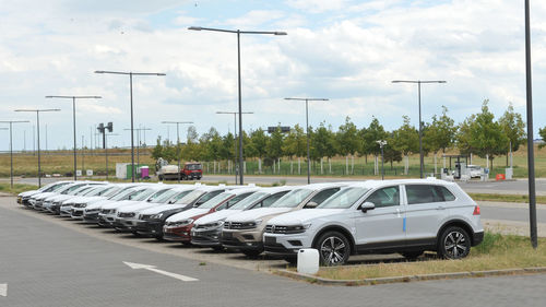 Cars on street in city against sky