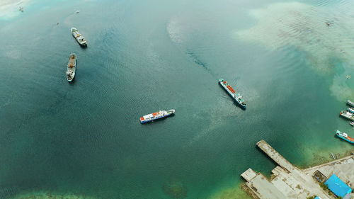 Freight ships and ferries in the bay, top view. dapa ferry terminal. siargao, philippines.