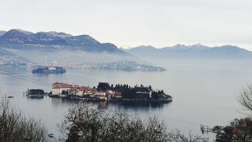 Scenic view of sea and mountains against sky