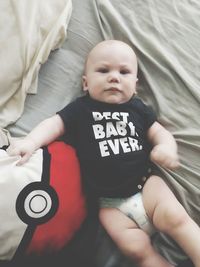 High angle view of cute baby lying on bed