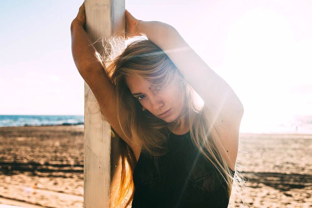 beach, sea, horizon over water, clear sky, water, shore, young adult, sand, lifestyles, leisure activity, focus on foreground, sky, tranquility, nature, person, long hair, standing, young women