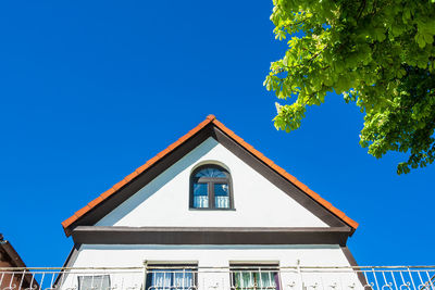Low angle view of building against clear blue sky