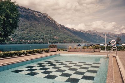 Scenic view of lake and mountains against sky