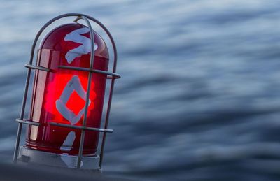Close-up of red ship in sea against sky