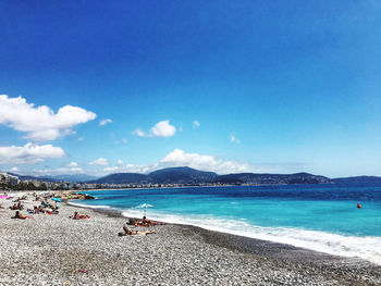 Scenic view of beach against blue sky