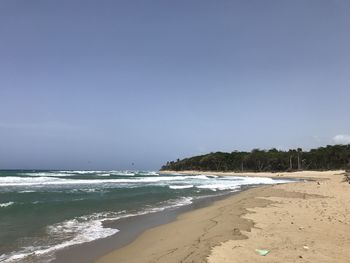 Scenic view of beach against clear sky