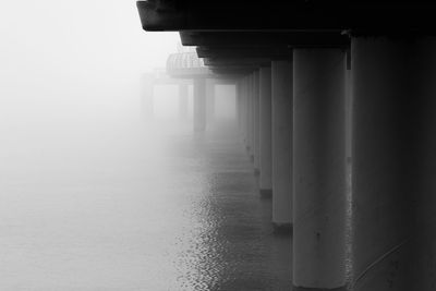 Pier over sea during foggy weather