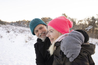 Woman wearing hat against snow during winter