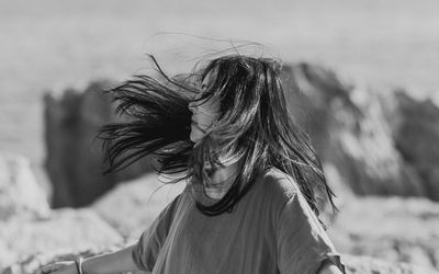 Young woman standing at beach