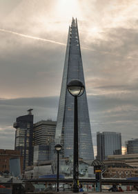 Low angle view of skyscrapers against sky during sunset