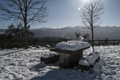 Scenic view of snow covered field against sky