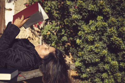 Woman holding an open book in the garden