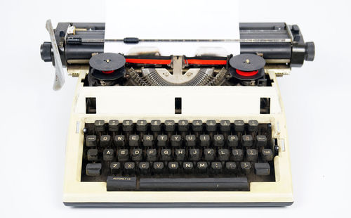 High angle view of old machine on table against white background