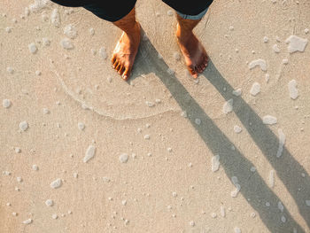 Low section of man standing on street