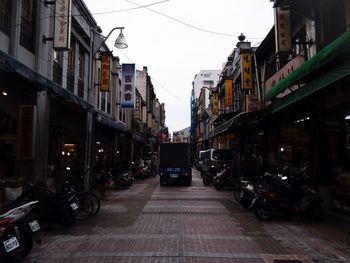 Cars on city street against clear sky