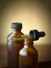 Close-up of perfume bottles with dropper on table