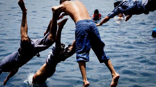 Friends swimming in sea