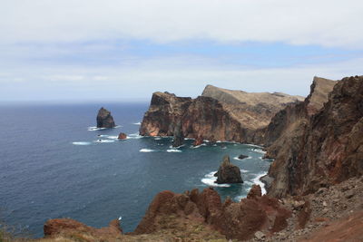 Scenic view of sea with mountain range in background