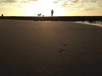 People at beach against sky