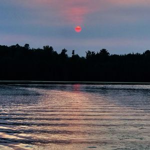 Scenic view of lake against sky during sunset