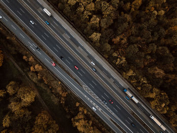 High angle view of cars moving on road amidst trees