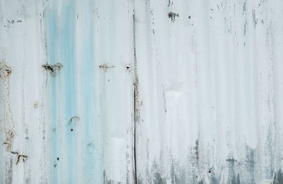 Galvanized sheet painted with white color. empty white wall texture background. peeling paint.