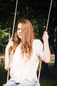 Young woman standing in park