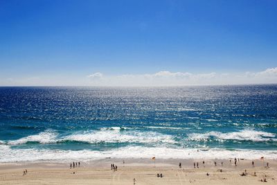 Scenic view of beach against blue sky